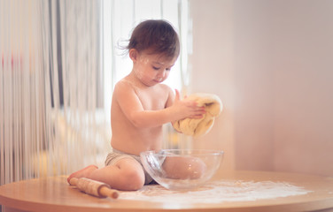 boy kneading dough in the kitchen