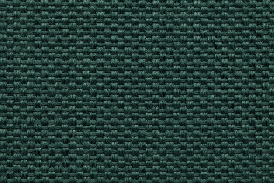 Green textile background with checkered pattern, closeup. Structure of the fabric macro.