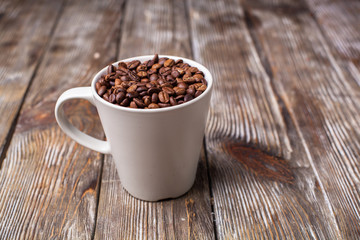 A cup filled with coffee beans