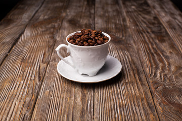 Coffee cup filled with coffee beans