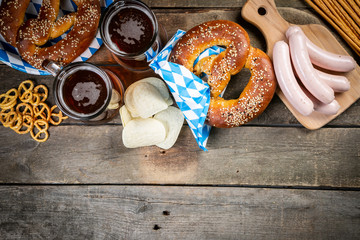 Oktoberfest concept - traditional food and beer on rustic background, copy space