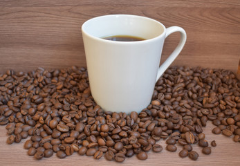 A cup among the coffee beans.