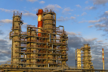 large complex of packed distillation columns and heating furnace in a modern chemical factory....