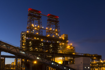 Night industrial landscape with bright lights of lanterns - 4-drum delayed coking unit in a...