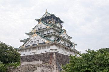 Osaka Castle with dramatic cloudy skies in Osaka, Japan.