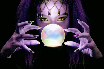 Witch in black are spelling dark magic with marble.