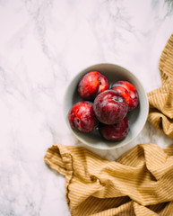 Plum on white marble background
