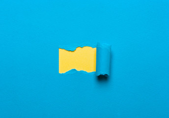 blue background of paper with a torn yellow space for the message,