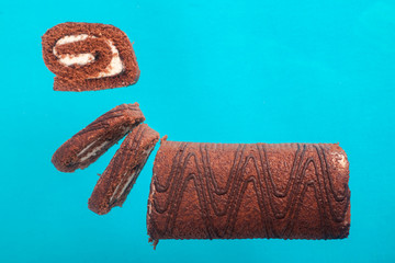Chocolate roll on a turquoise background