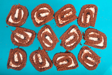 Chocolate roll on a turquoise background