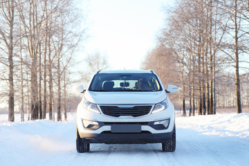the car stands on a snow-covered road in a wintertime