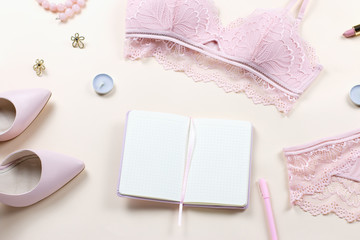 Woman elegant pink lace bra and panties, pumps and jewelry. Stylish lingerie flat lay.