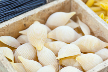 Close up of Organic brown rice shell pasta, uncooked, preparing dried pasta