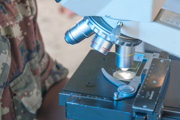 Scientist of Royal thai Army Medical  working with a microscope in laboratory