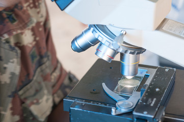 Scientist of Royal thai Army Medical  working with a microscope in laboratory