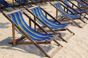 beach chairs on sand beach.