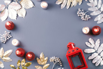 Winter concept flat lay with lantern, candles and silver leaves, copy space