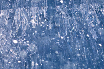 Fototapeta na wymiar Texture of ice in winter. Pieces of frozen water on a street in 