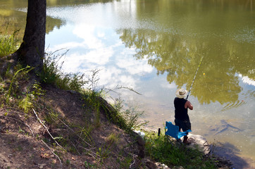Man Standing Next To River Fishing
