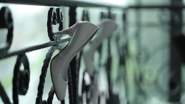 White shoes hang on the railing Macro shot shot glidetrack