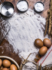 Pastry Baking Accessories Bakery Background with flour and whisk. Ingredients for the preparation of bakery products.