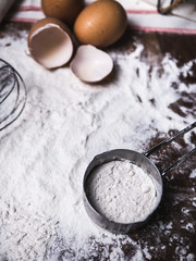 Pastry Baking Accessories Bakery Background with flour and whisk. Ingredients for the preparation of bakery products.