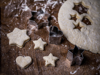 bakery Cookie dough with cutting mold on kitchen table.