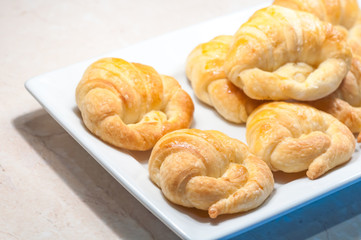 close up of croissants in white dish for breakfast in morning time
