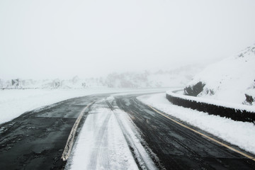 Ice, snow and fog - Snowstorm in the high mountains road. Concept - safe travel for winter holidays, weather