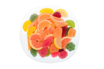 Colored fruit marmalade on the white plate. Lemon, apple, orange, grapefruit. Jelly colour background