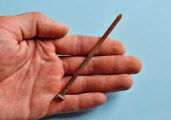 Rusty nail in hand