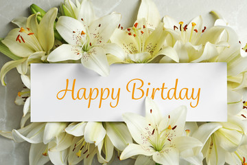 Beautiful lily flowers and blank card, top view