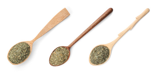 Set of spoons with dried parsley on white background, top view
