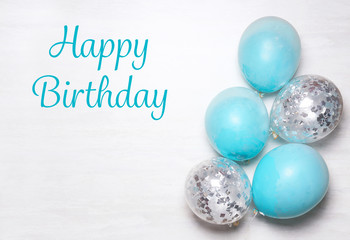 Flat lay composition with colorful balloons and space for text on light background