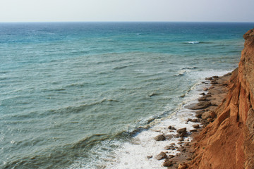 Sea waves, surf. Rocks and cliffs. Black Sea. Summer. View from above