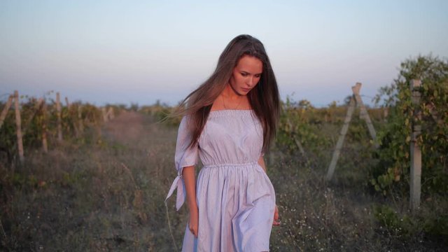 girl in white dress walking in the evening