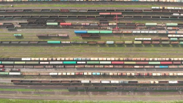 Branches of the railway at the marshalling yard, a lot of freight wagons from the height. Wagons with coal moving on rails