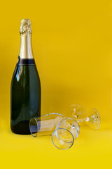 Fototapeta premium Bottle of champagne with yellow background