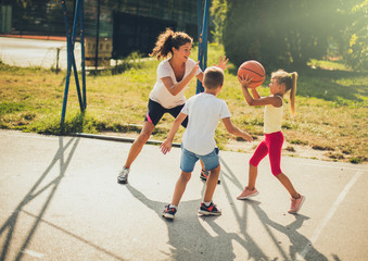 Family time. Family playing basketball together.