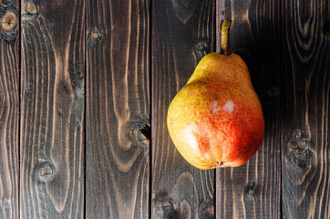 Bright red-yellow pears in a basket.