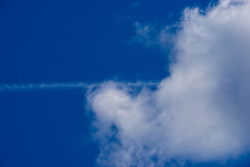 Summer clouds, airplane trail