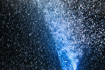 Illuminated water jets. Blue color