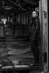 portrait Young woman with long grounge red hair posing in an abandoned place full of graffity black & white