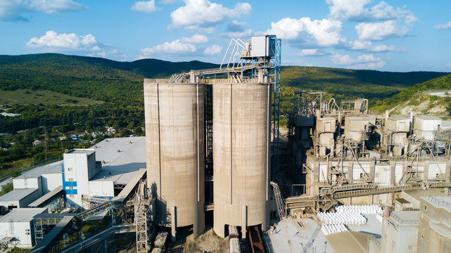 Aerial view of cement manufacturing plant. Concept of buildings at the factory, steel pipes, giants.