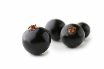 Black currants isolated on white background