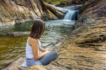 woman sitting on a rock