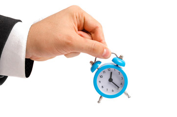 A businessman is holding an alarm clock. Watch in hand. The concept of hourly pay, time. Late for work. Full or incomplete rate. Overtime at work. Pension and savings contributions.