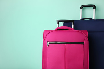 Blue and pink suitcases on mint background