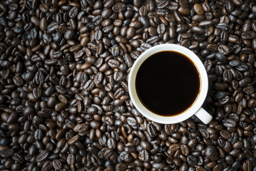 Espresso coffee above coffee beans