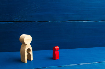 A wooden figure of a woman with a void in the form of a child inside the body stands and looks at the child. The concept of infertility in women, the loss of a child. Adoption, reunification. A family